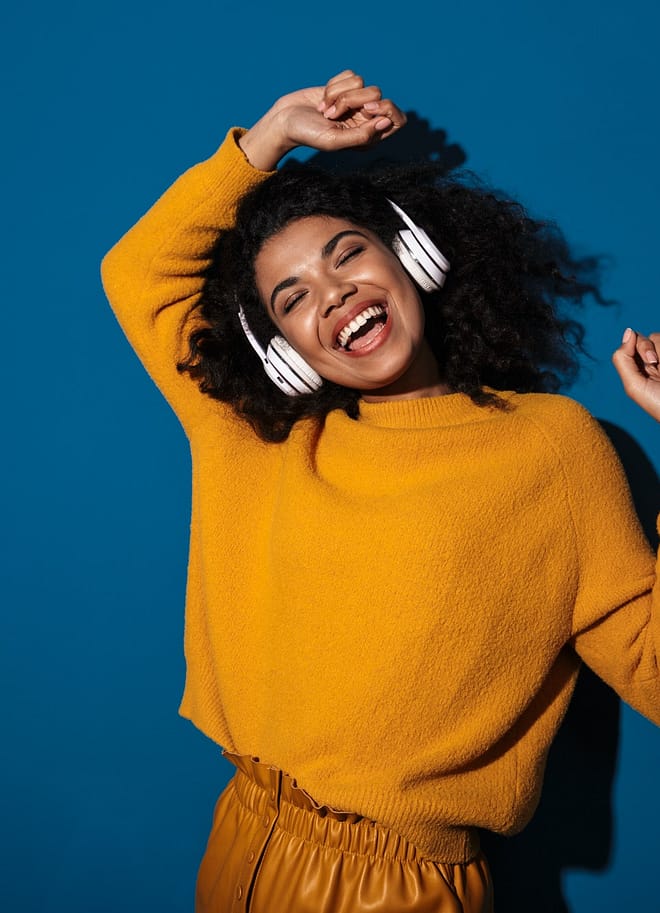 Woman posing isolated listening music with headphones.